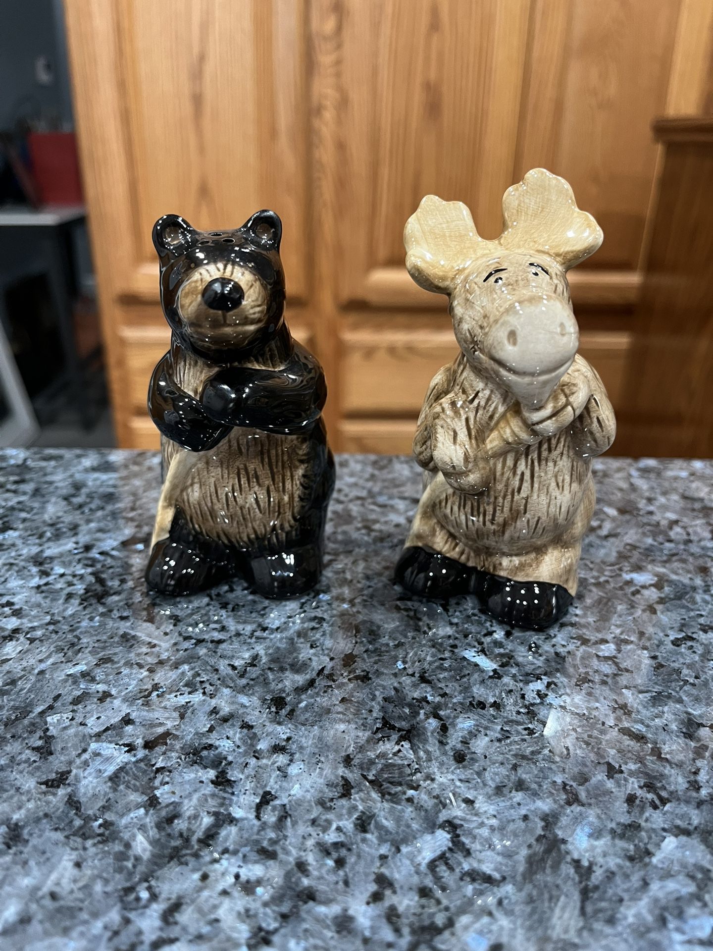 Ceramic a standing moose and Bear pair of salt and pepper shakers. Size approximately 4 inches tall. Preowned no chips or cracks.