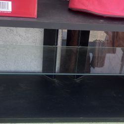basic black TV stand with a glass shelf (2-tier, no drawers, used condition)