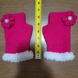 Handmade floral accent with a jeweled center Crocheted fingerless glove hot pink with a white faux fur cuff