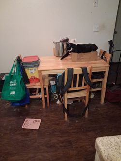 Rectangular kitchen table with four chairs.