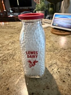 Vintage Lewes Dairy Quart Glass Milk Bottle. Approximately 7 inches tall. Includes the original Lewes Dairy paper cap. These are very rare to find wit