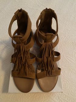 Brown short wedged sandals.