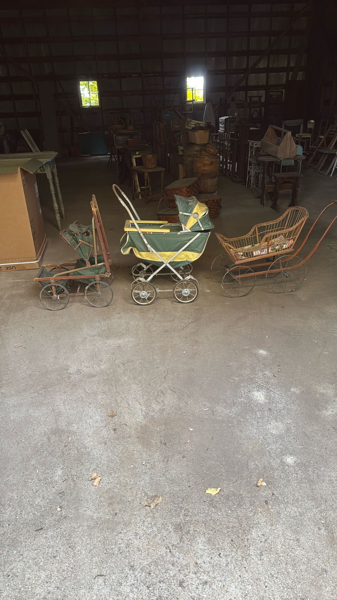 Three antique baby strollers