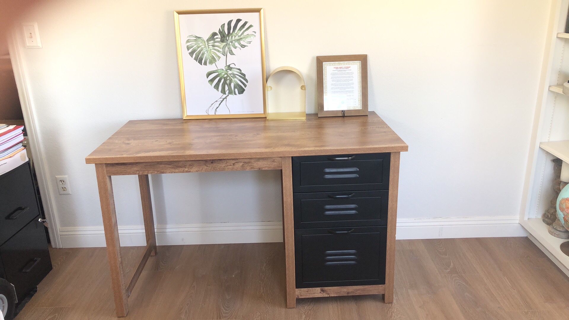 Desk with filing cabinet, wooden frame and gold done shelf