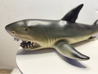 Made of dense, elastic rubber with a soft interior filling, making it safe for water play. Detailing: The figure features a distinctive dark-gray back