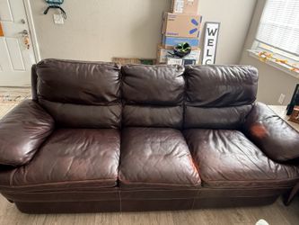 Kane’s Brown leather sofa and matching chair