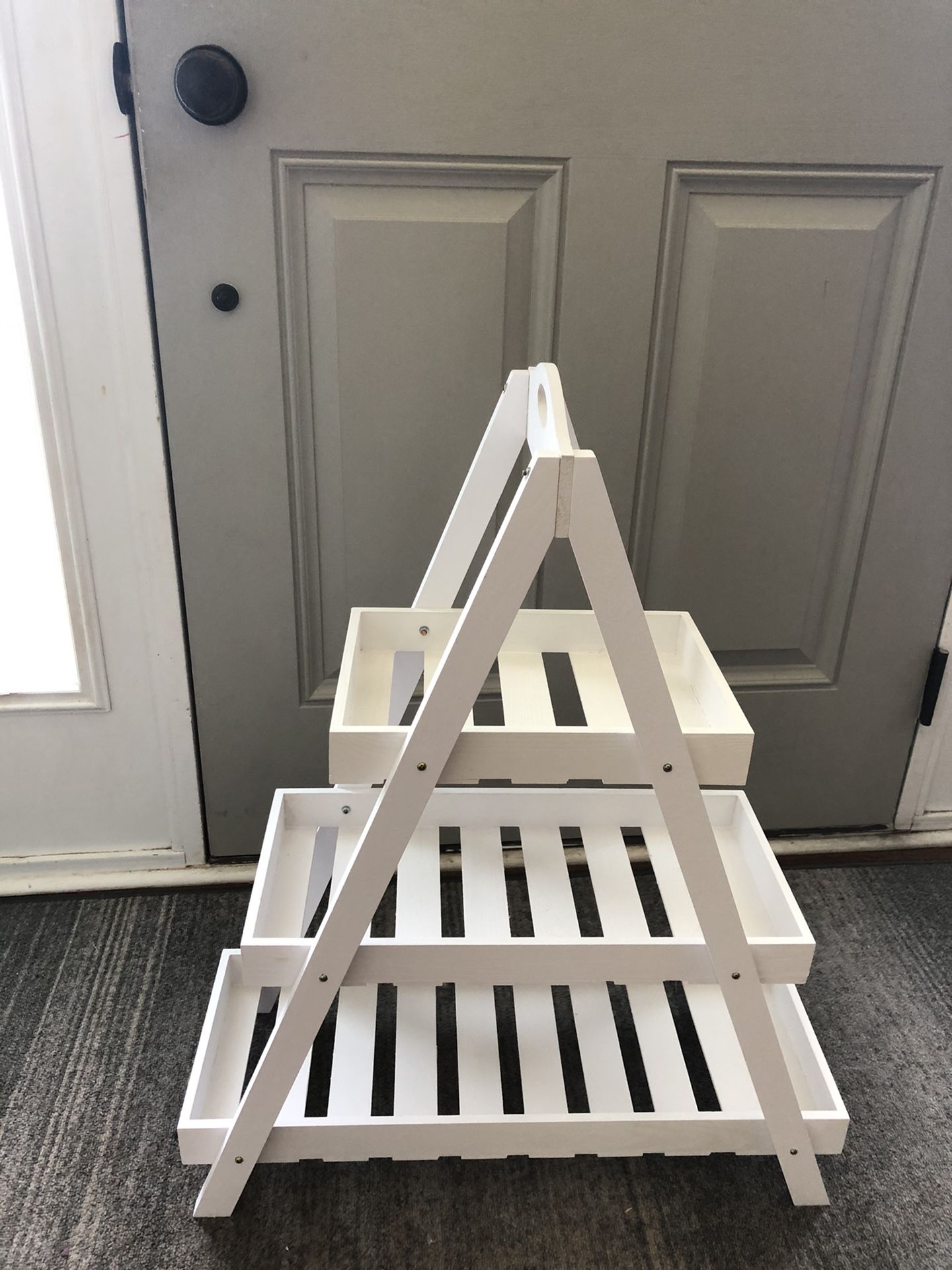 Small white wood plant shelf.