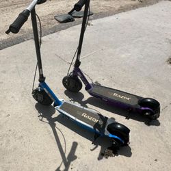 2 Razor E100 Black Label Electric Scooters. One Works Perfectly. One Needs A Charger