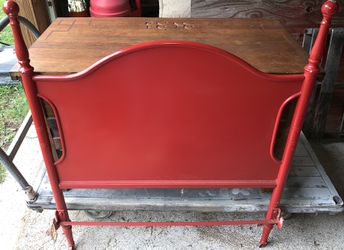 Old twin cast iron bed with mattress springs and rails