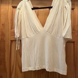 Banana Republic top for women, dressy design on top of each arm. Color white. In great condition. Size Xl Stretchy material. Made in Korea