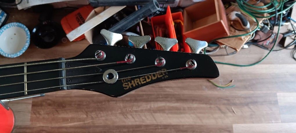 The shredder, black electric Base guitar.