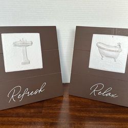(2) Kohl’s Sturdy decorative wooden bathroom signs featuring relief tiles of a sink and a bathtub.