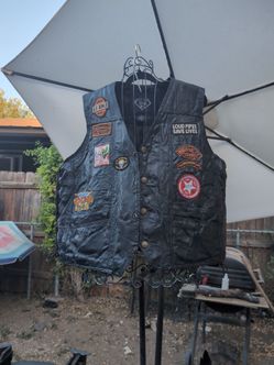 This is a Diamond Plate Genuine Buffalo Leather Biker Vest loaded with custom-sewn motorcycle rally, biker lifestyle, and commemorative patches.