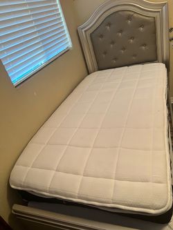 Twin bed with mattress and nightstand