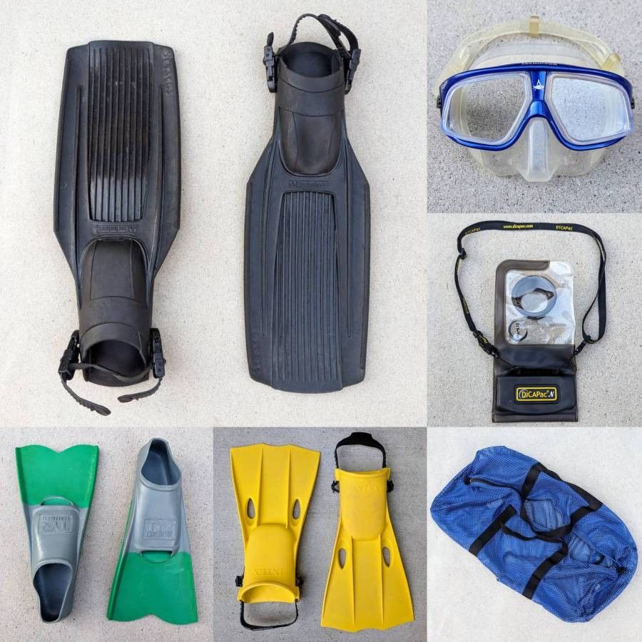 Assortment of scuba gear diving fins swimming flippers water shoes snorkel mask weight belt