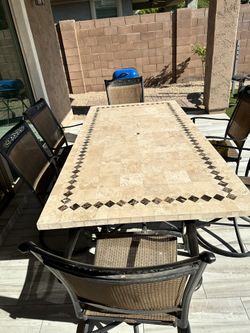 Travertine table with 4 rocking chairs and 2 armchairs