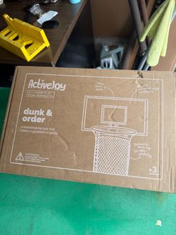 Wooden laundry basket wiht a ring over the door for clothes