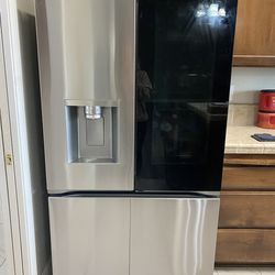 LG French door refrigerator with InstaView (glass panel) and bottom freezer.