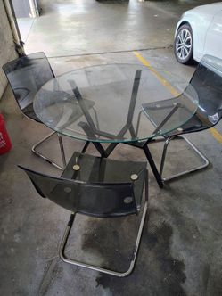 $150 o. b. o.  Glass table w/3 clear chairs