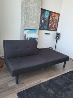 Futon And Pics On The Wall.