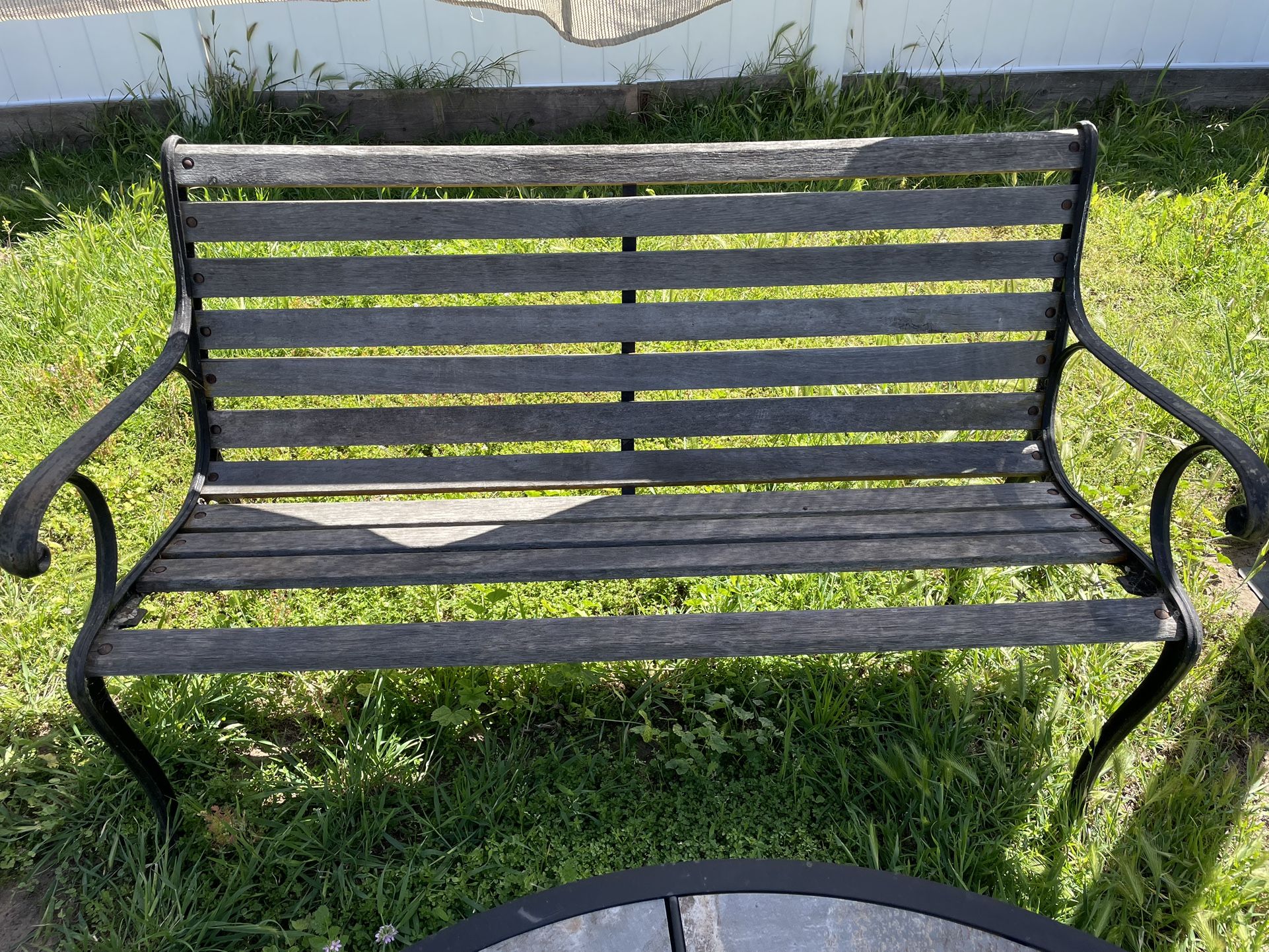 Preowned rod iron bench seating outdoor front door backyard