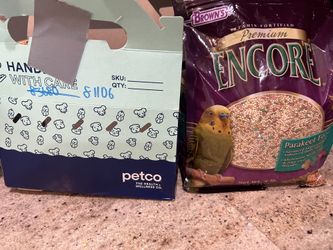 A Bird, Cage And Food As A Set.