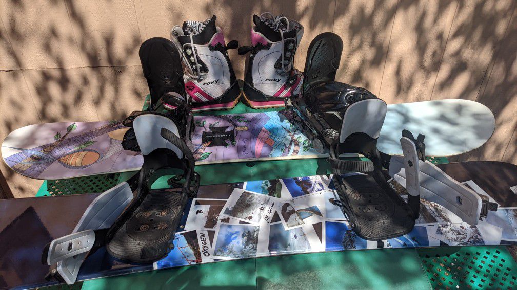 HIS AND HERS SNOWBOARDS.