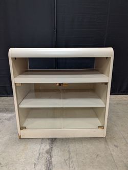Compact Cream Storage Cabinet with Glass Doors and Curved Design