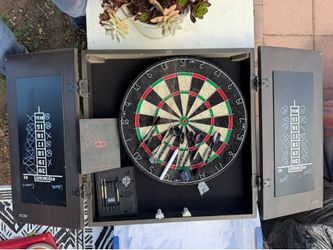 Quality Dart board with darts and marker ready to play.
