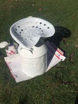 Steel Traktor sit on milk container.