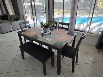 Table with four chairs and bench