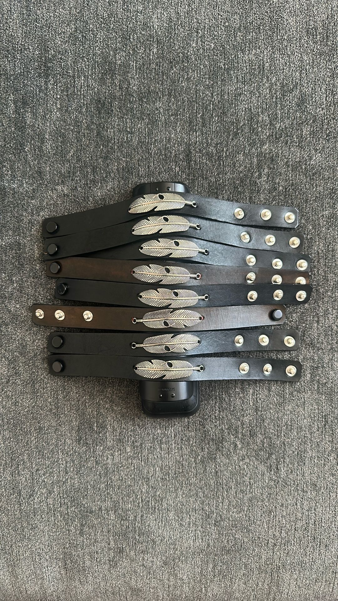 Adjustable leather button bracelet with feathers