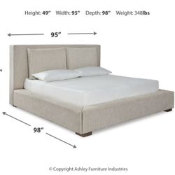 Ashley Furniture Langford King Upholstered Bed and Pillows, includes mattress, nightstands, and lamps.