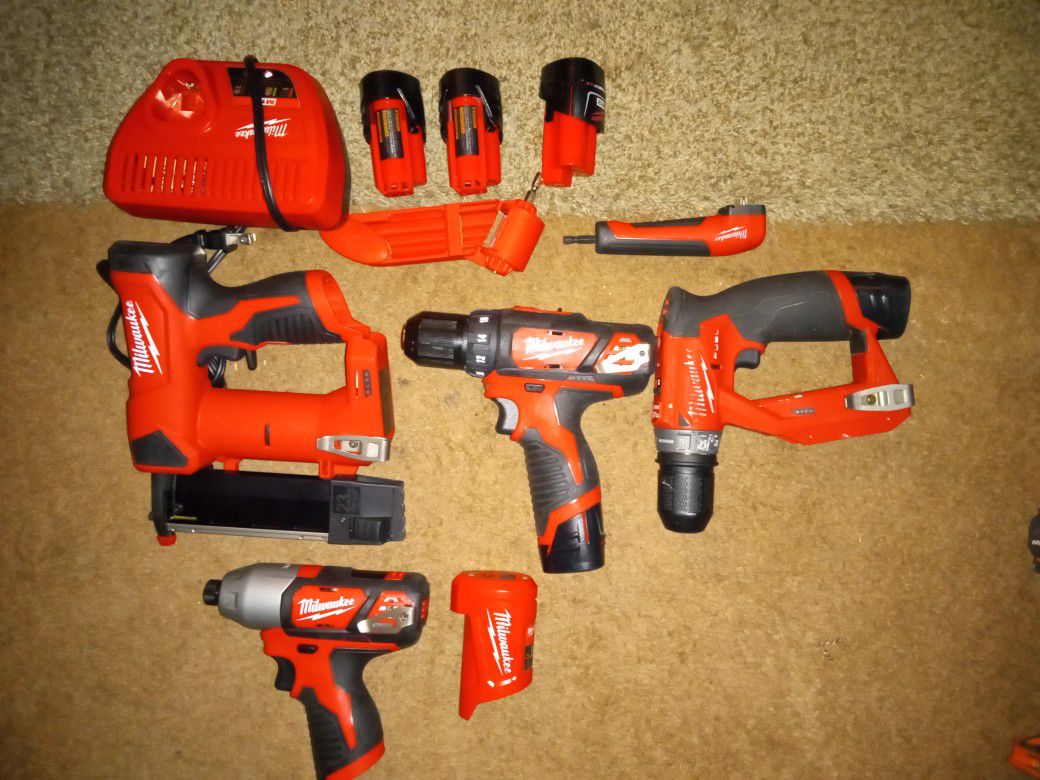 Milwaukee Set 3 3/8 M12 Drills Power Bank Nail Gun Which Is An M28 And All Charger And Accessories Angled Drill Bit And A Drill Bit Sharpener