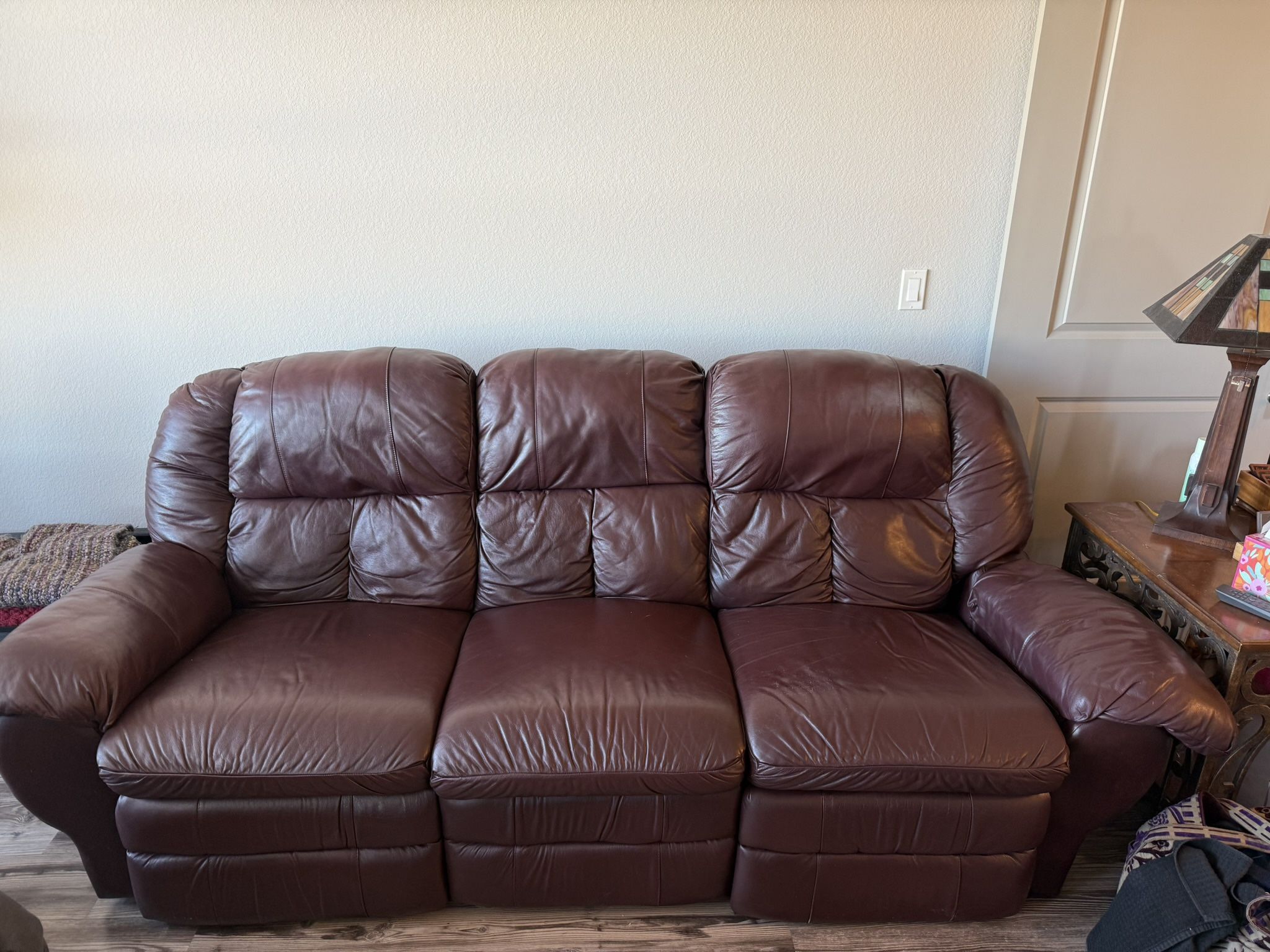Leather reclining couch and manual recline leather chair and end table