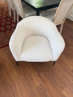A pair of beautiful off white fabric arm chairs
