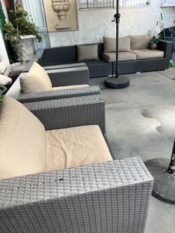 Rattan patio set with minor damage (shown in the photos); some cushions are missing.
