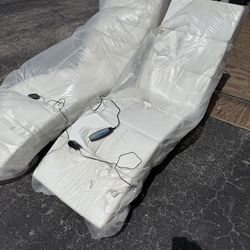 Two white chaise massage chairs