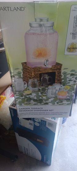 Like new beverage dispenser with glasses.