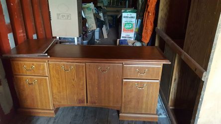Nice wooden desk has 2 drawers and extra storage. A pullout shelf in middle. Good shape