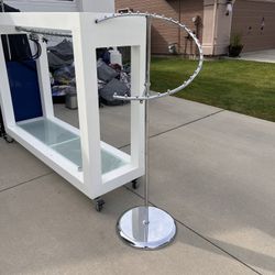 Beautiful Metal And Glass Display With Bar For Hanging Items 