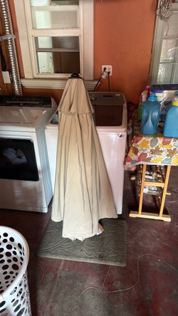 Folded Beige Patio Umbrella