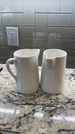 2 white pitchers