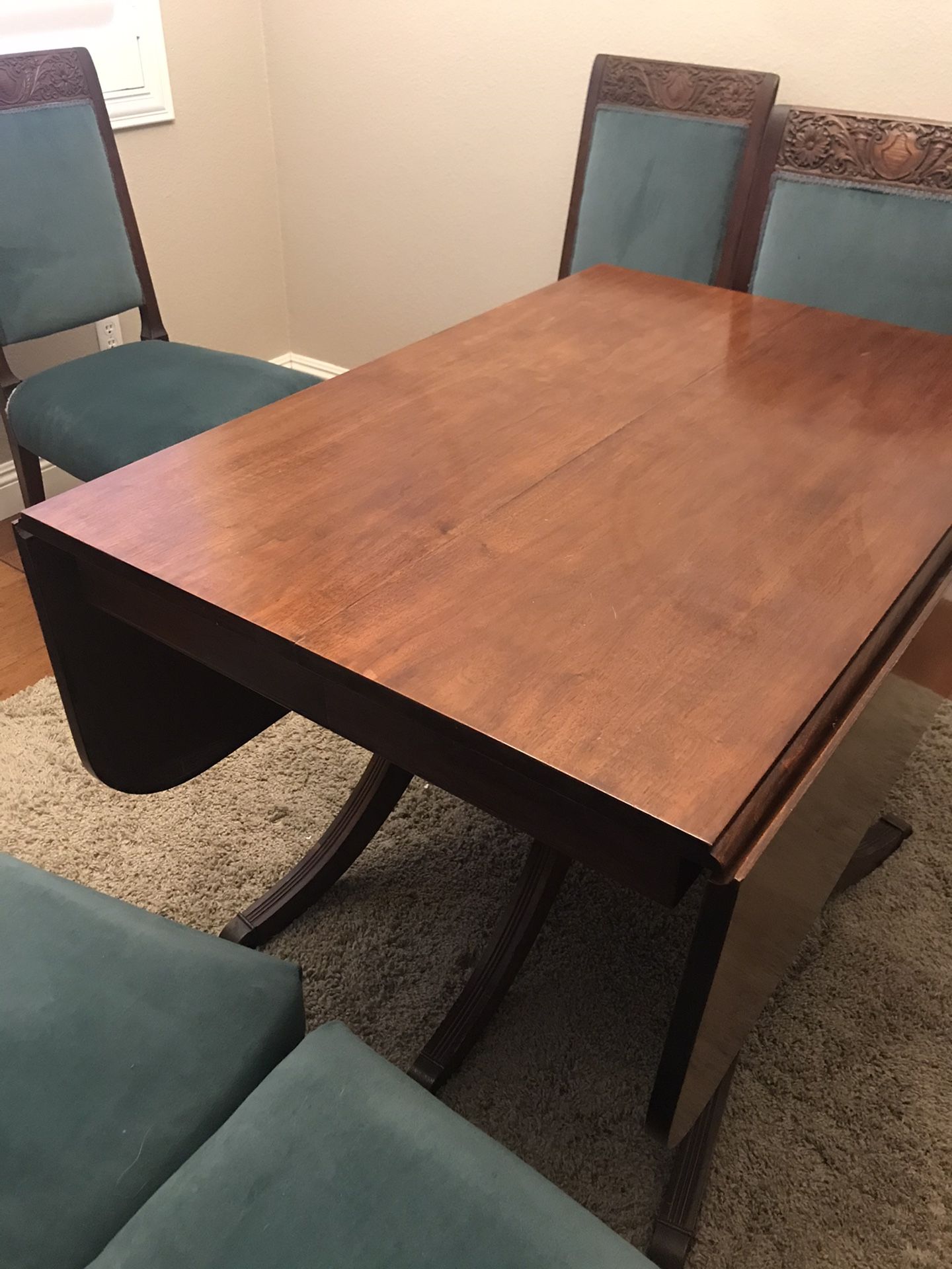 Antique dining table and 6 chairs. Slight repair needed on one chairs upholstery coming loose from frame.