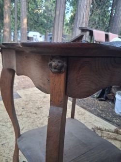 old antique table with lions heads on corner of table