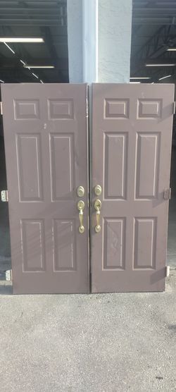 Exterior metal double doors approximately 30x30x79 couple small dents very easy fix