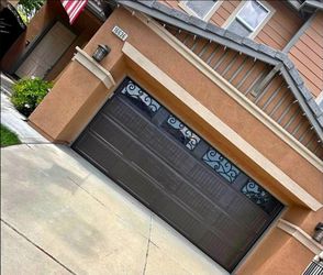 Dark Brown Garage Door with Decorative Iron Windows