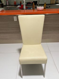 Eight modern cream, upholstered chairs with chrome legs