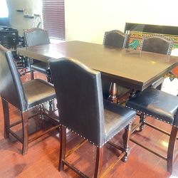 Brown farmhouse, dining room, table, and chairs