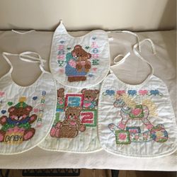 4 Hand Cross Stitched Baby Bibs.